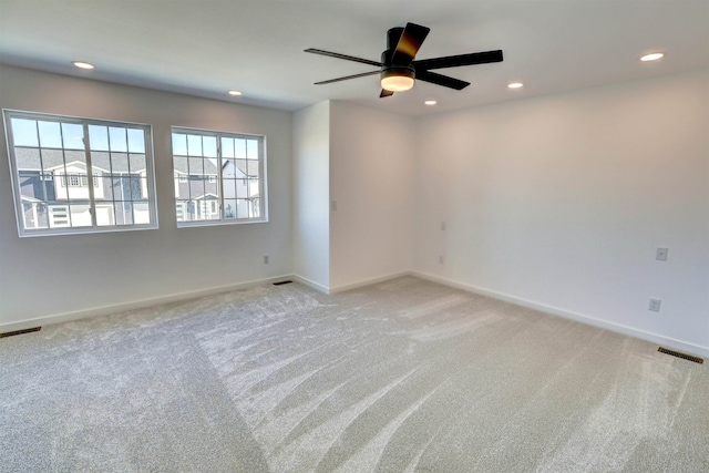 carpeted spare room with ceiling fan