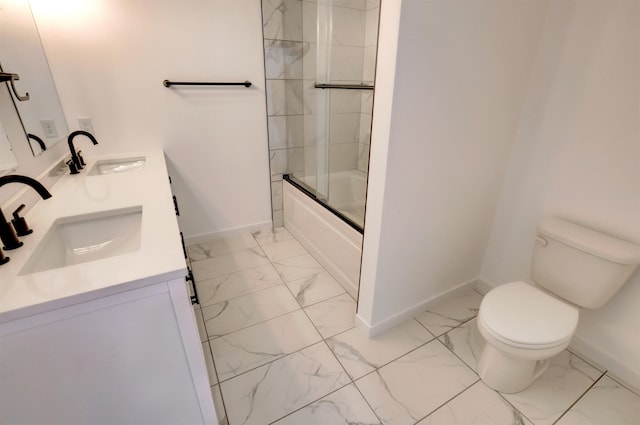 full bathroom featuring vanity, toilet, and bath / shower combo with glass door