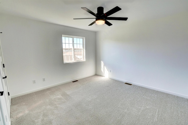 spare room with ceiling fan and carpet