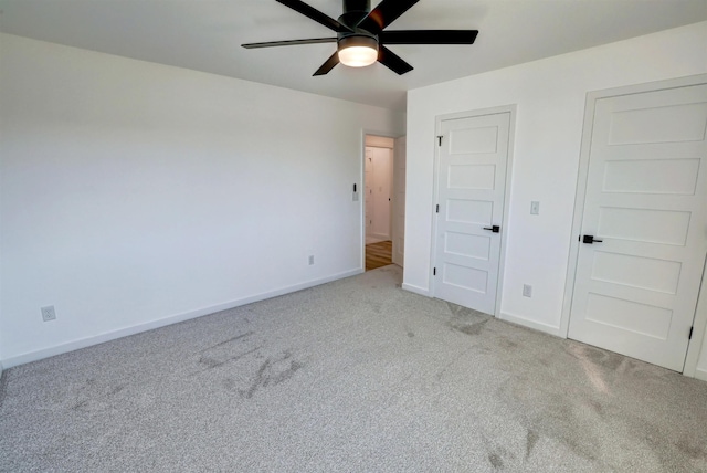 unfurnished bedroom featuring ceiling fan and light colored carpet