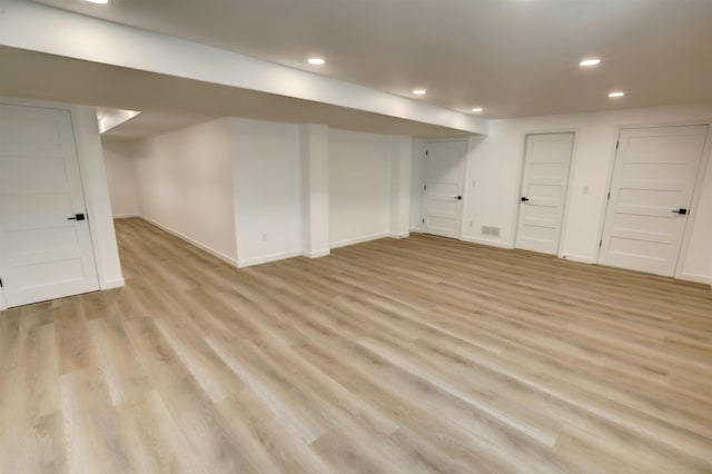 basement with light hardwood / wood-style floors