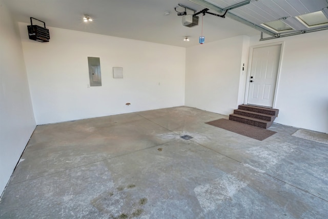 garage with electric panel and a garage door opener