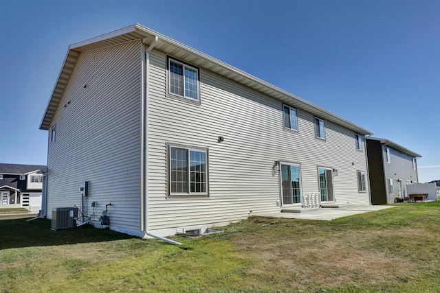 back of house featuring a lawn, a patio area, and central AC unit