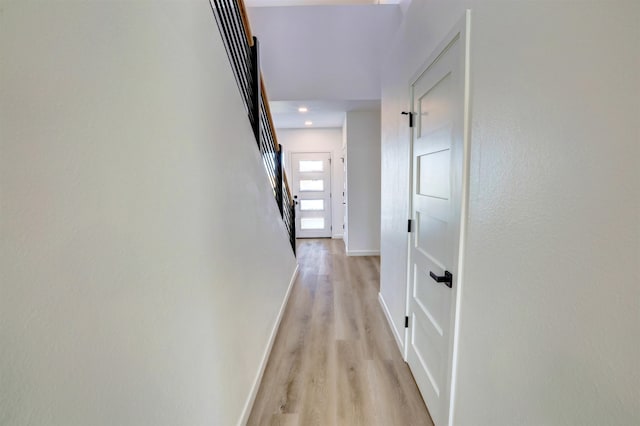 hall with light hardwood / wood-style floors