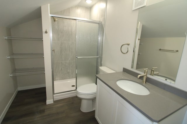 bathroom with vaulted ceiling, hardwood / wood-style floors, toilet, a shower with shower door, and vanity