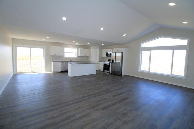 unfurnished living room with lofted ceiling, sink, and dark hardwood / wood-style floors