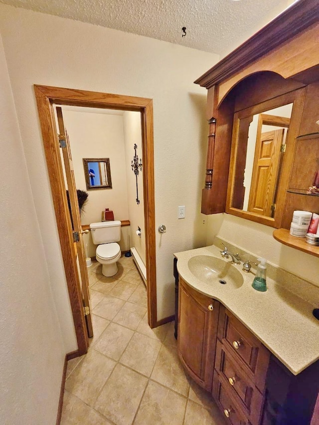 1103 3rd Ave, Rugby, ND 58368 - half bathroom featuring toilet, tile patterned flooring, vanity, baseboard heating, and a textured ceiling