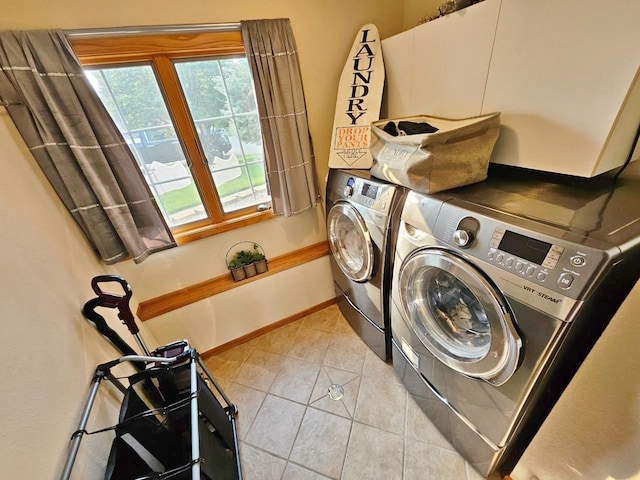 laundry area featuring independent washer and dryer and light tile patterned flooring