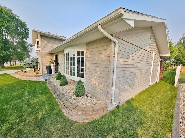 view of side of property with a yard