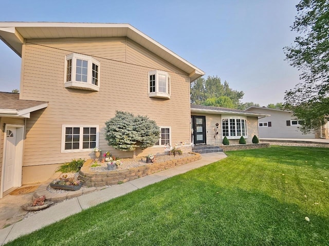 rear view of property with a yard