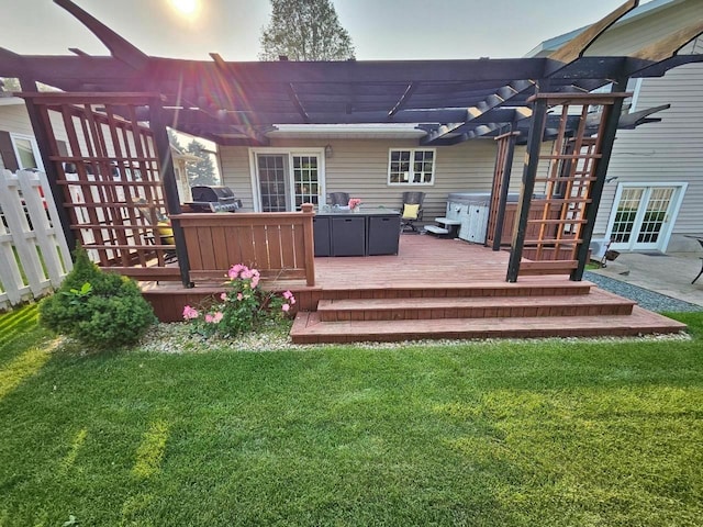 deck featuring a grill, a pergola, a lawn, and french doors