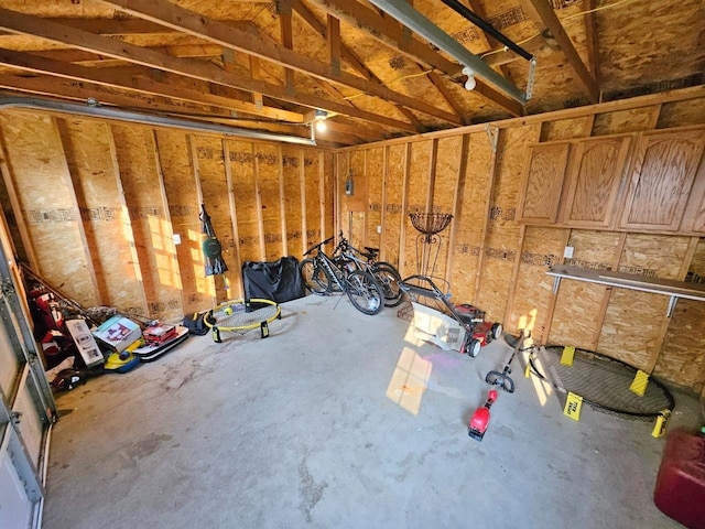 interior space with vaulted ceiling and concrete flooring