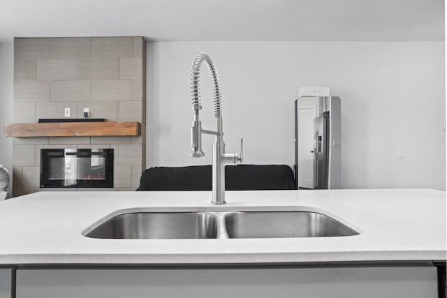 2424 Landmark Dr, Minot, ND 58703 - details featuring a sink, light countertops, and a large fireplace
