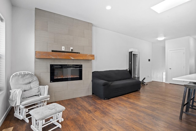 2424 Landmark Dr, Minot, ND 58703 - sitting room with a fireplace, wood finished floors, and baseboards