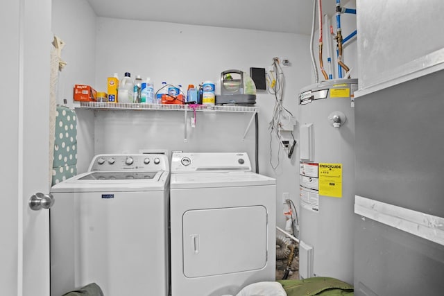 2424 Landmark Dr, Minot, ND 58703 - laundry room with laundry area, washing machine and clothes dryer, and electric water heater