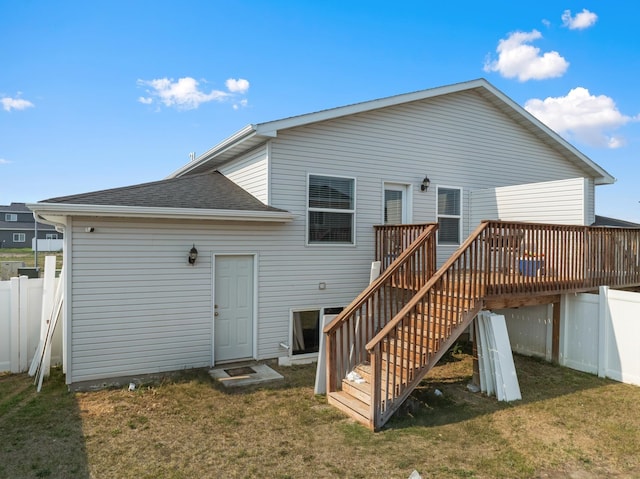 2424 Landmark Dr, Minot, ND 58703 - back of property with stairway, fence, a lawn, and a wooden deck