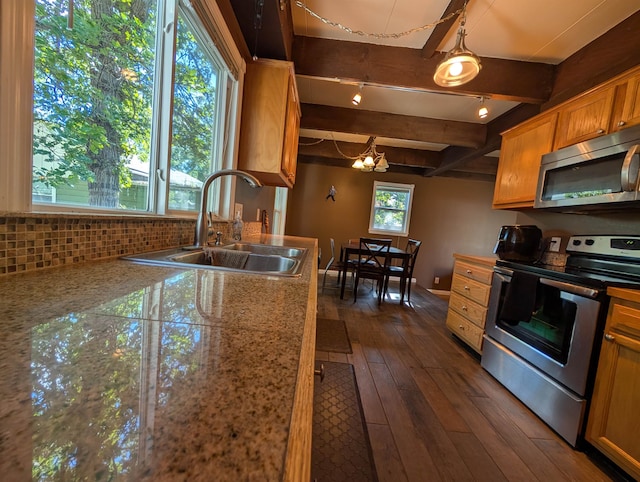 kitchen featuring beamed ceiling, dark hardwood / wood-style floors, sink, an inviting chandelier, and appliances with stainless steel finishes