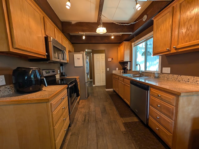 kitchen featuring track lighting, dark hardwood / wood-style floors, sink, beam ceiling, and appliances with stainless steel finishes