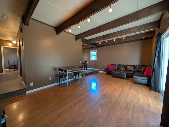 living room featuring light hardwood / wood-style floors and beamed ceiling