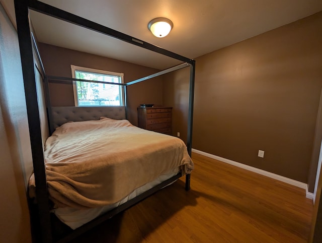 bedroom with hardwood / wood-style floors