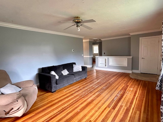 unfurnished living room with ornamental molding, ceiling fan, and light hardwood / wood-style flooring