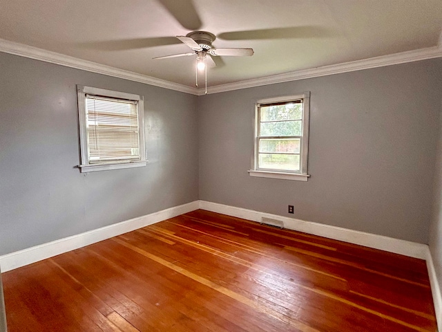 spare room featuring ceiling fan, crown molding, and wood-type flooring