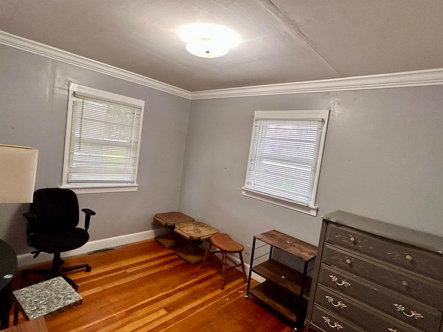 living area featuring crown molding, hardwood / wood-style floors, and plenty of natural light