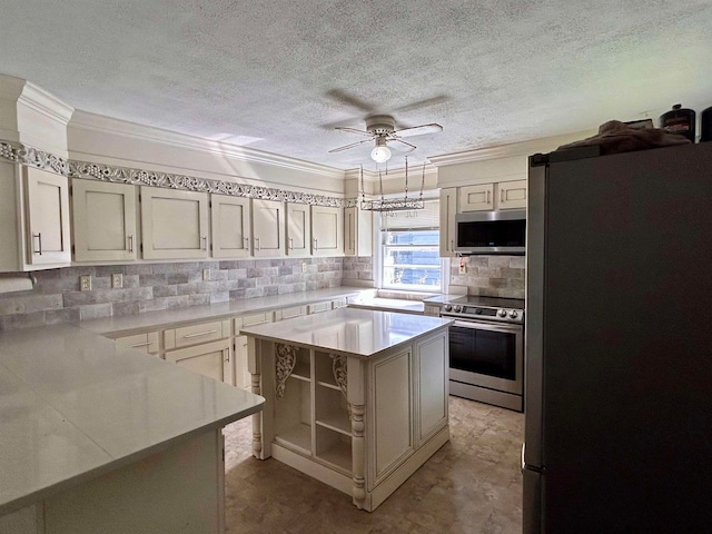 kitchen with ceiling fan, ornamental molding, tasteful backsplash, a kitchen island, and appliances with stainless steel finishes