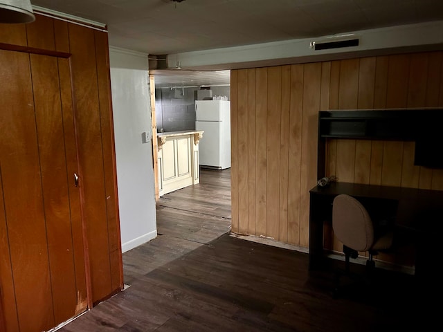 interior space with wooden walls and dark hardwood / wood-style floors