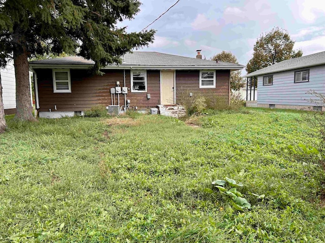 back of house with a lawn