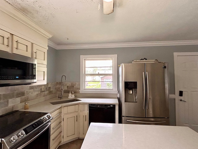 kitchen with tasteful backsplash, stainless steel appliances, crown molding, cream cabinets, and sink