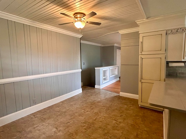 empty room featuring ceiling fan, crown molding, and wooden ceiling