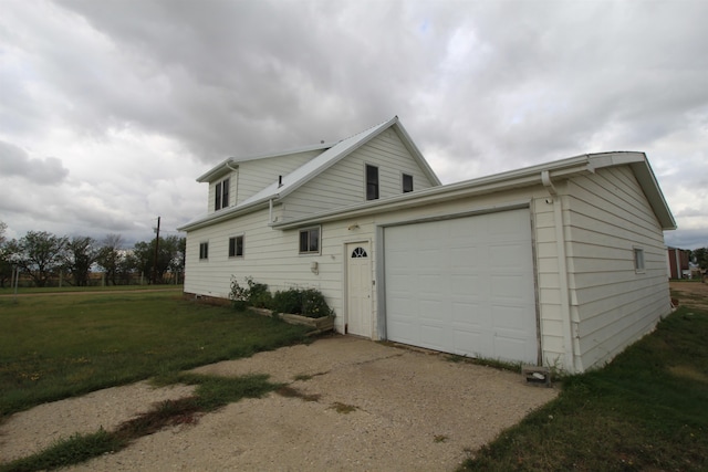 view of property exterior featuring a lawn and a garage