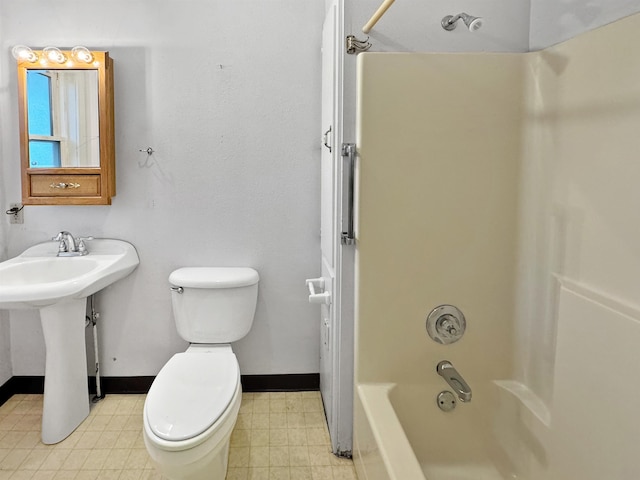 bathroom featuring tub / shower combination and toilet