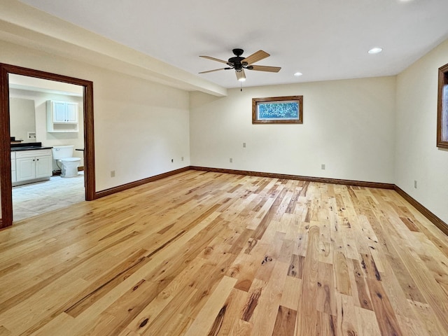 spare room featuring ceiling fan and light hardwood / wood-style flooring