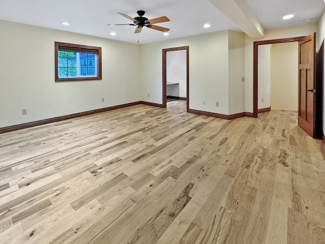 spare room with light wood-type flooring and ceiling fan