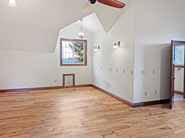 additional living space featuring ceiling fan, light wood-type flooring, vaulted ceiling, and a wealth of natural light