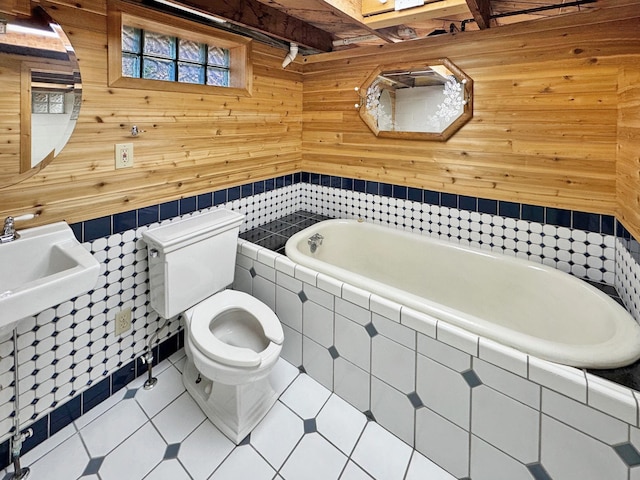 bathroom with beamed ceiling, toilet, wooden walls, tiled bath, and tile patterned flooring