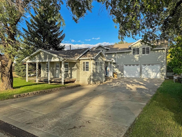 view of front of house featuring a garage and a front lawn