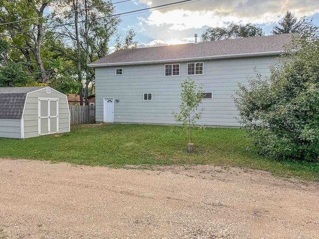 exterior space featuring wood walls and a yard