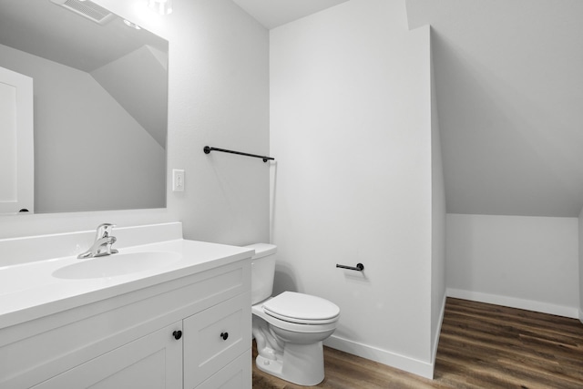 bathroom featuring wood-type flooring, vanity, and toilet