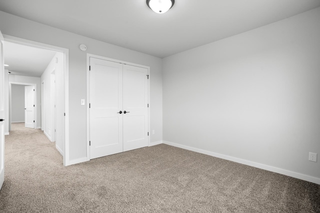 unfurnished bedroom featuring a closet and carpet flooring