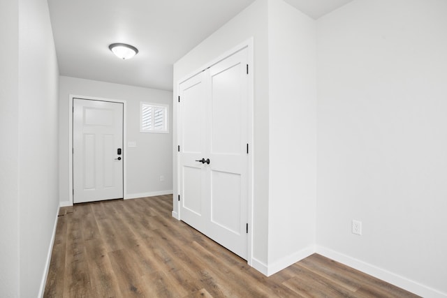 hall with hardwood / wood-style floors