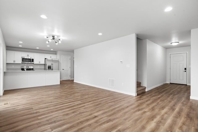 unfurnished living room featuring light wood-type flooring