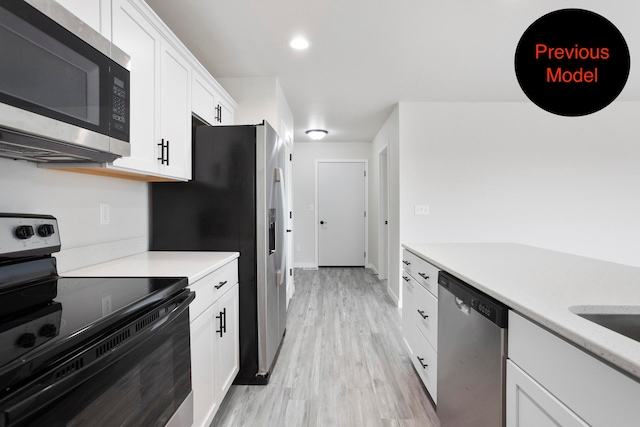 kitchen featuring light hardwood / wood-style floors, white cabinetry, and stainless steel appliances