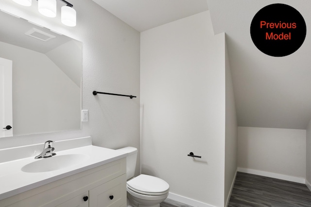 bathroom featuring wood-type flooring, vanity, and toilet