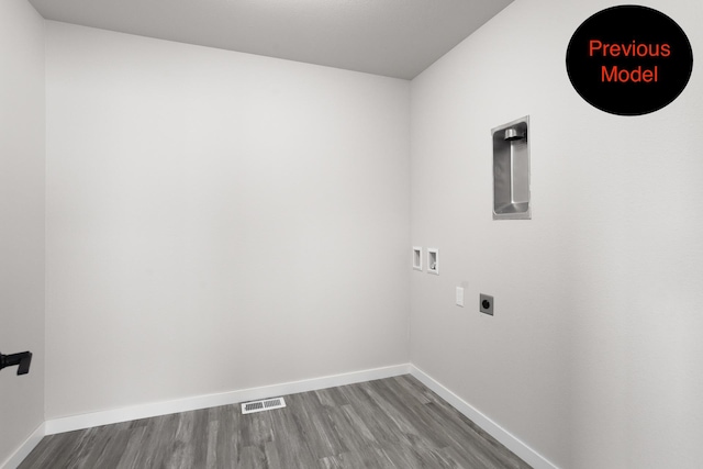 clothes washing area featuring hookup for an electric dryer, hookup for a washing machine, and hardwood / wood-style floors