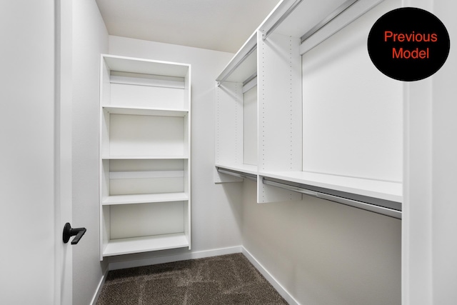 spacious closet with dark carpet