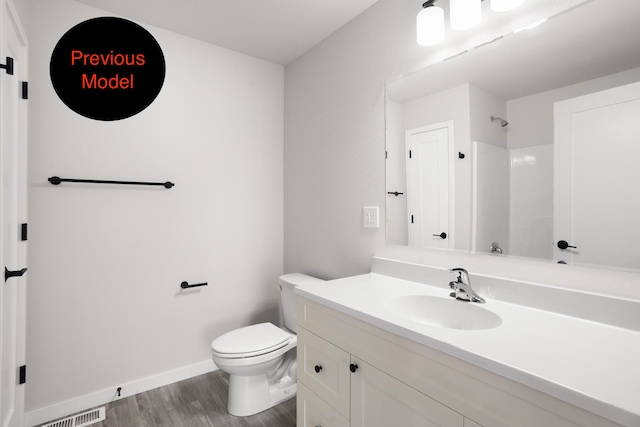 bathroom featuring hardwood / wood-style flooring, vanity, and toilet