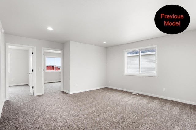 unfurnished room with light carpet